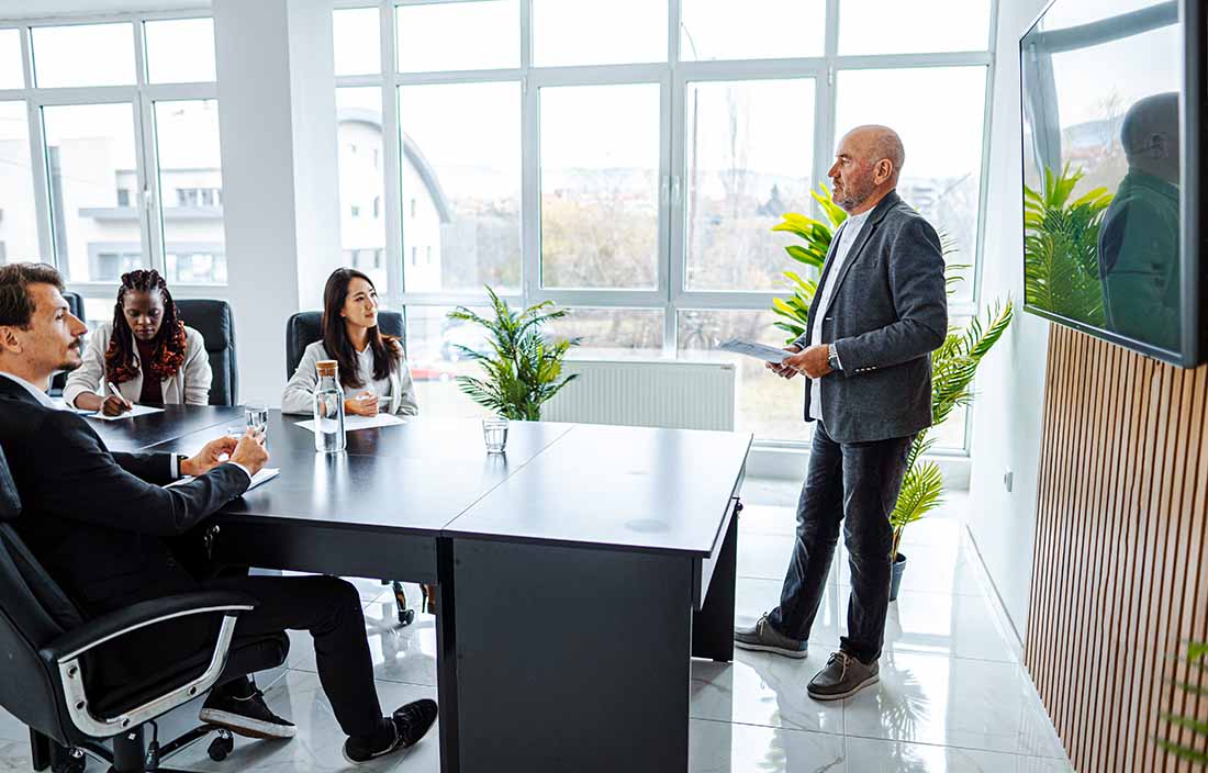 Business professionals in a modern conference room discussing the employee retention credit. 