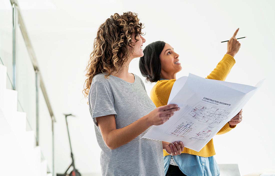 Two real estate developers going over blueprints.