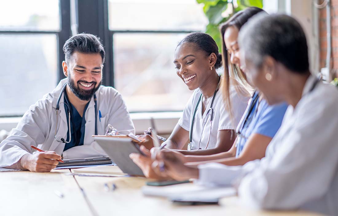 A small group of medical professionals in a team meeting.