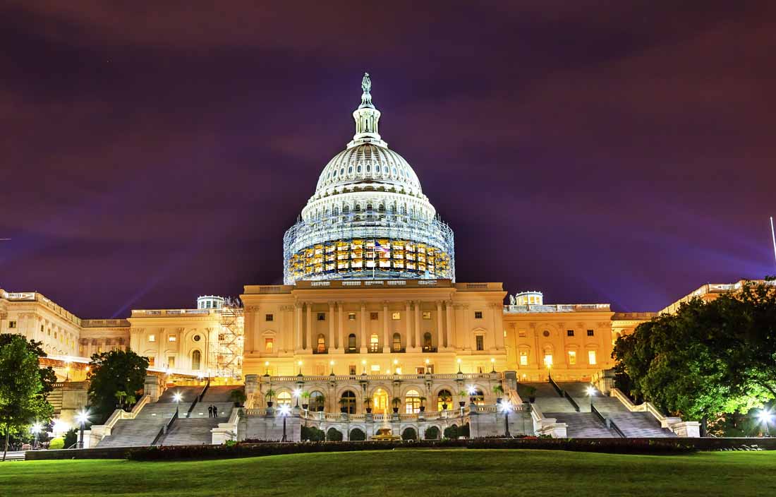 View of U.S. Capitol lit up at night.