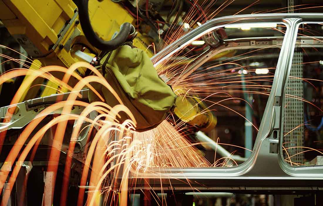 Sparks flying in automotive factory.