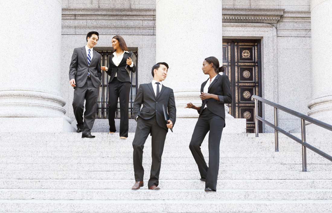Business professionals walking down the steps of a government building discussing an investment fund court ruling.
