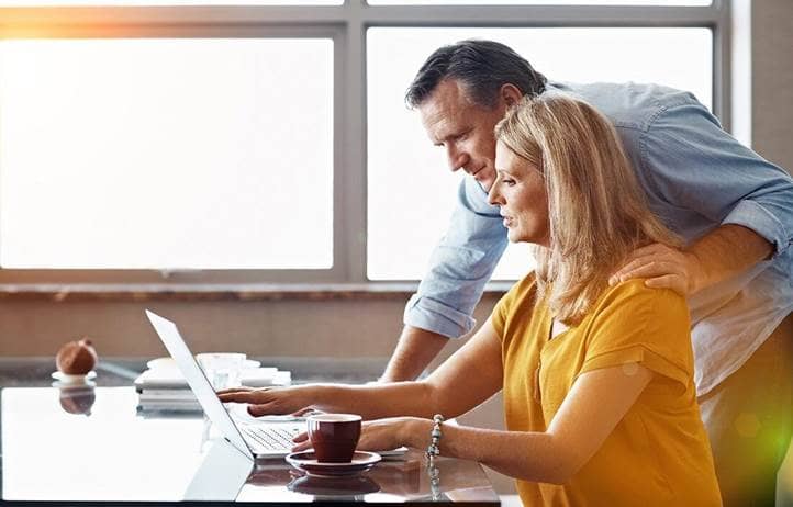 A couple reviewing life insurance annuities on their laptop computer