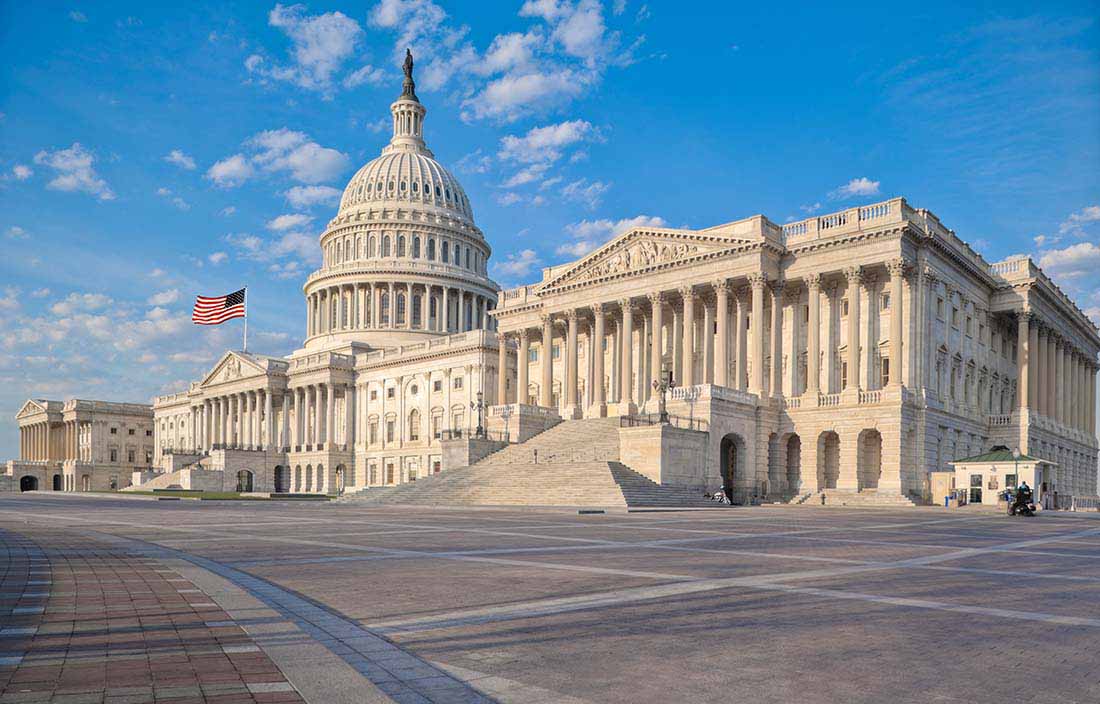 View of U.S. Congressional building against a blue sky.