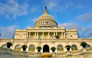 View of U.S. Capitol against the blue sky.