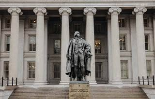 Statue in front of a U.S. government building.
