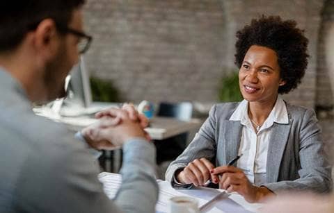 Business professionals talking about federal financial assistance for grants.