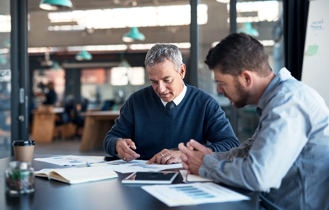 Two bankers discussing reports.