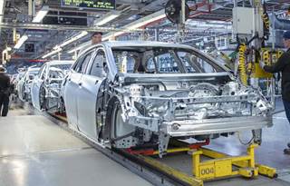 Close-up photo of a metal car frame in a factory