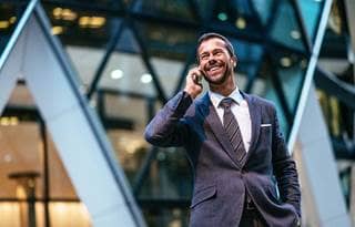 Business professional on phone outside of their office.