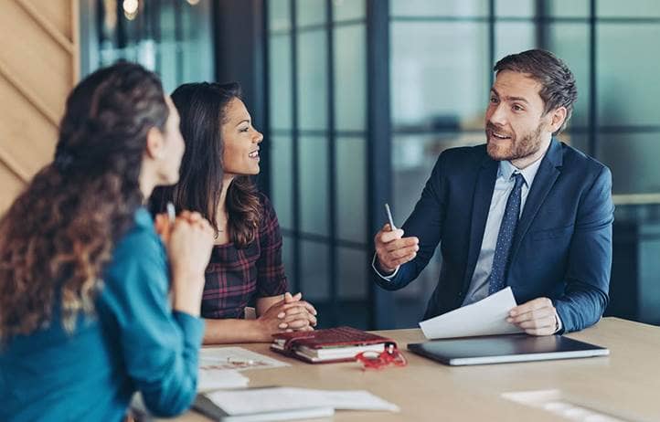 Coworkers discussing internal controls.