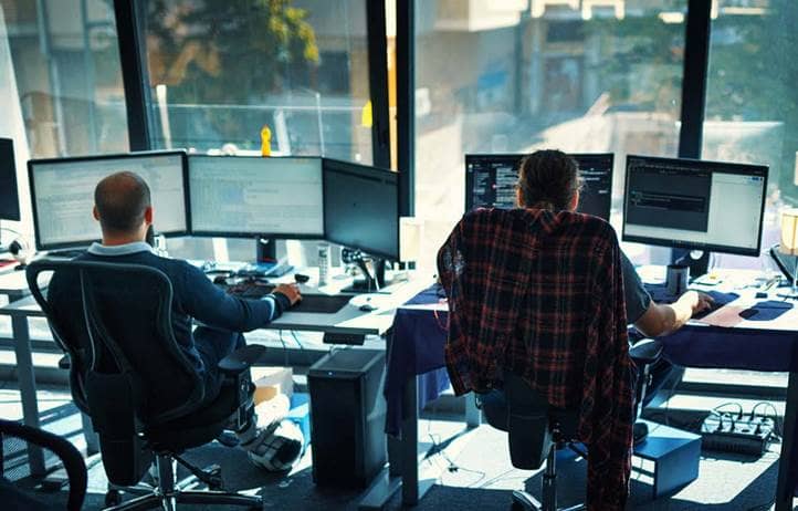 Software developers working on computers at the office.