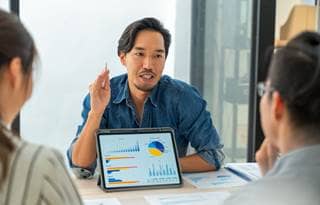 ERP consultant showing a chart to their clients.