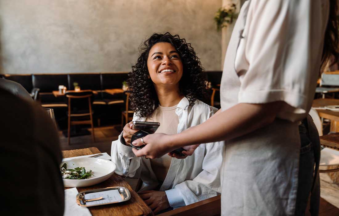 Person paying for their food at a restaurant.