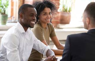 Couple talking to their wealth advisor.