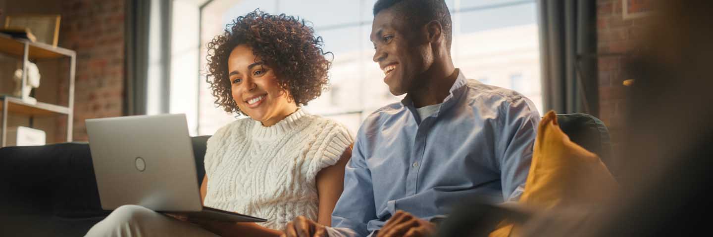 Couple reading an article on their laptop.