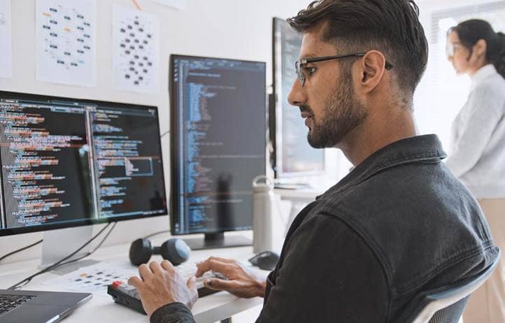 IT professional looking at code on their computer.