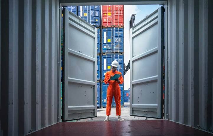Factory worker inspecting shipments.