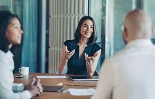 Business professionals talking in a modern conference room.