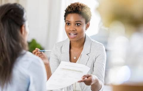 Business professional holding a pen and a piece of paper