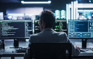 Cybersecurity professional working at their computer.