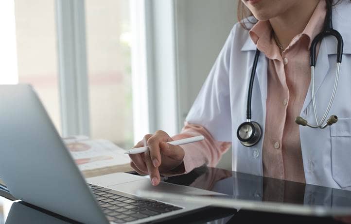 Medical professional on their computer.