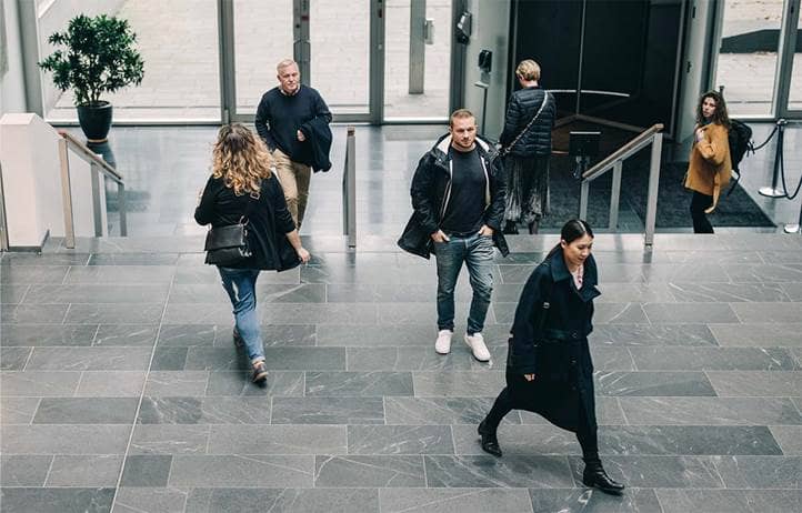 Businesspeople walking in an office building.