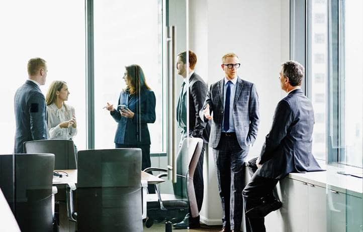 Group of financial advisors in a modern conference room.