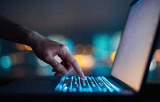 Person typing on a laptop.