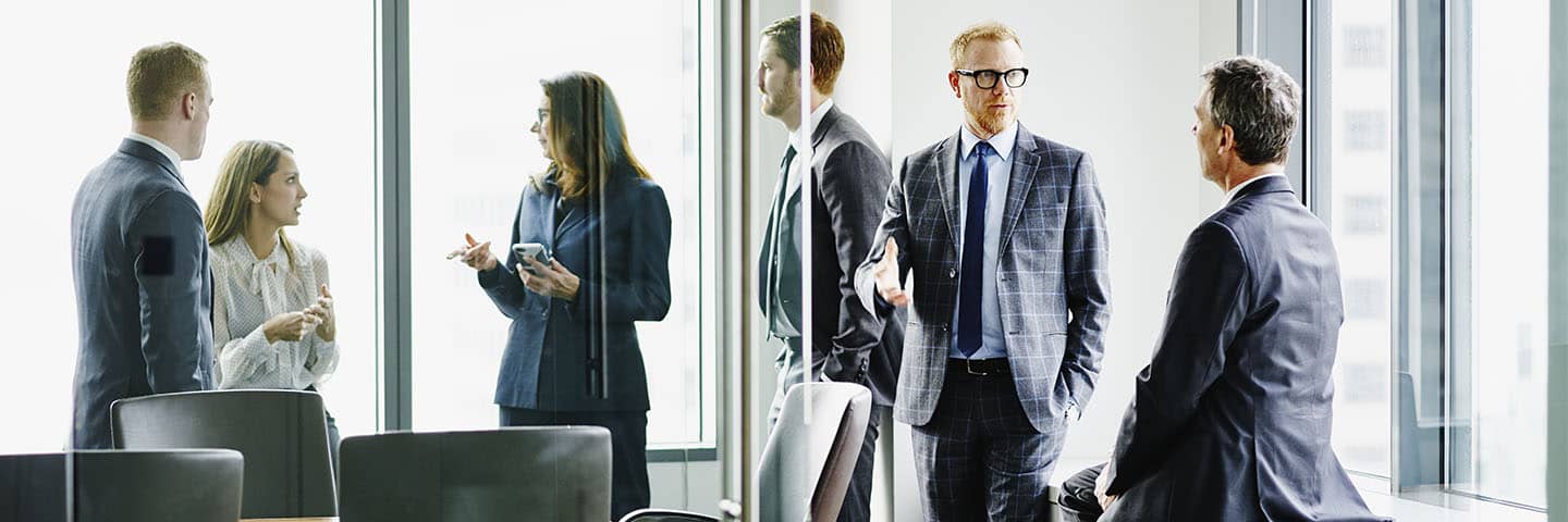 Group of financial advisors in a modern conference room.