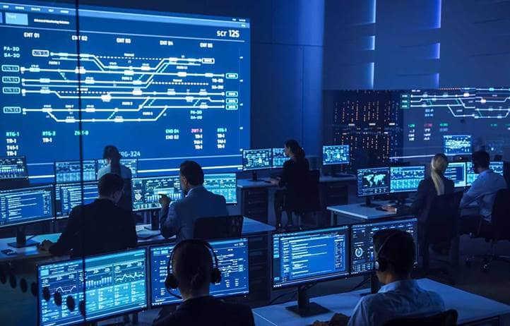 Cybersecurity professionals in a tech center.