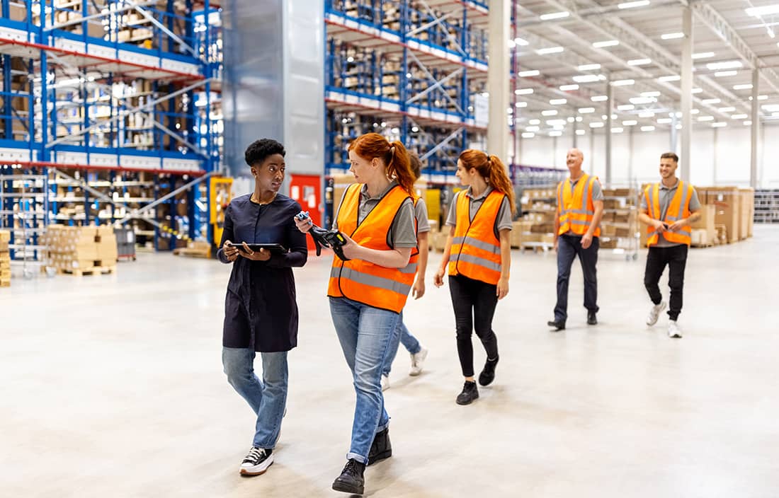 Group of manufacturing professionals walking around a factory.