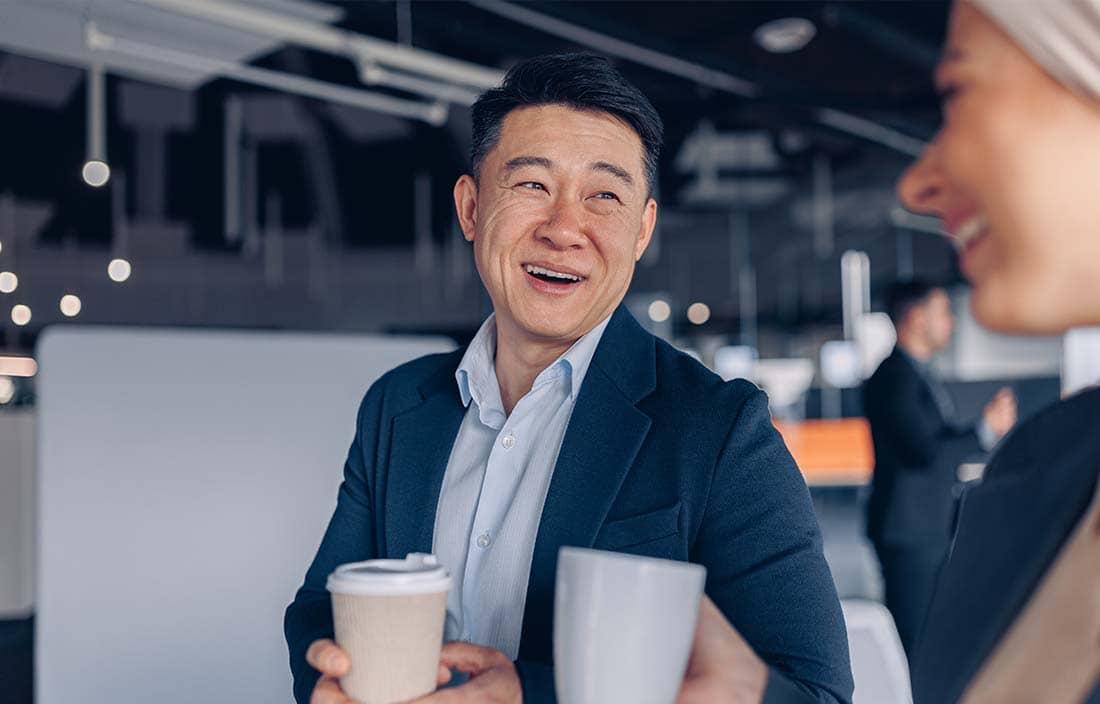 Business professionals talking and grabbing coffee.