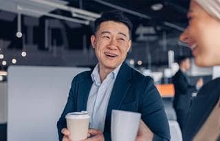 Business professionals talking and grabbing coffee.