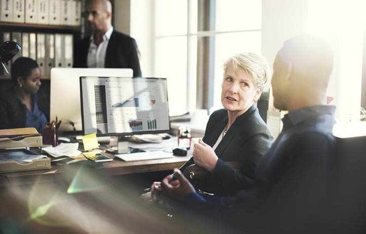 Business professionals discussing Section 1202.