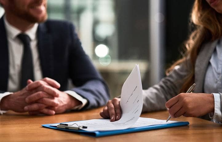 Financial professionals talking about compliance updates.