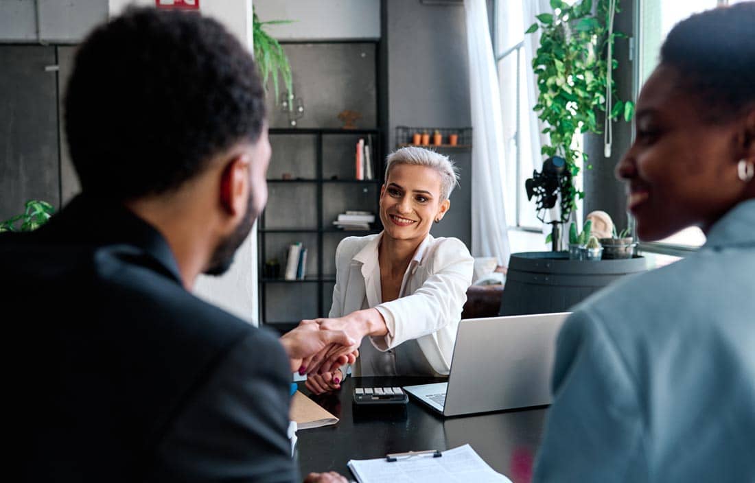 Benefit plan professional meeting with their clients and shaking hands.