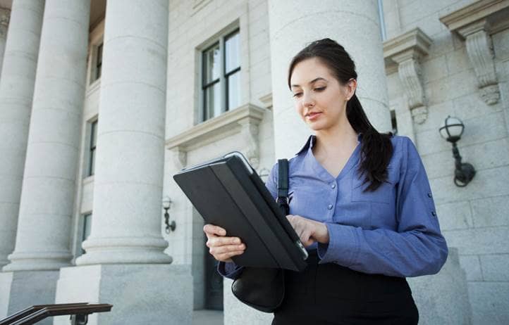 Local government professional reading about AI on their tablet.