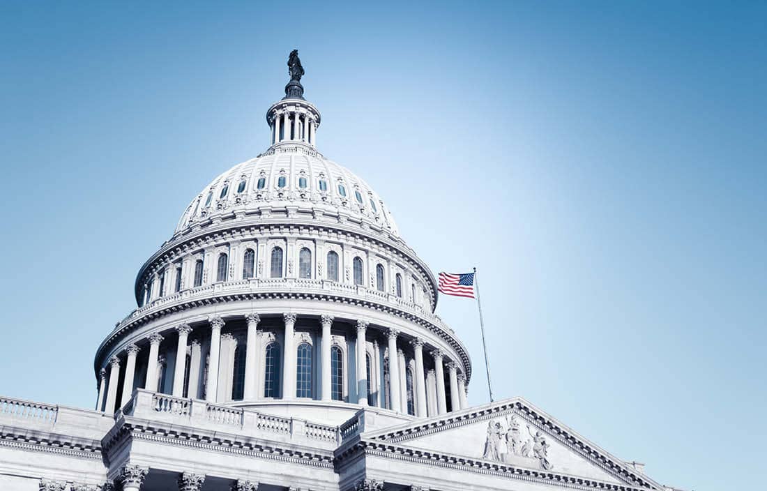 U.S. Capitol building against a blue sky.