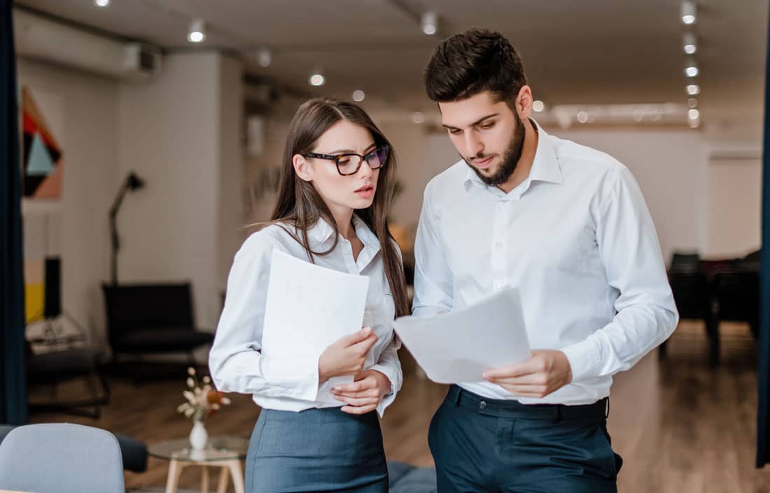 Two business professionals reviewing a document.