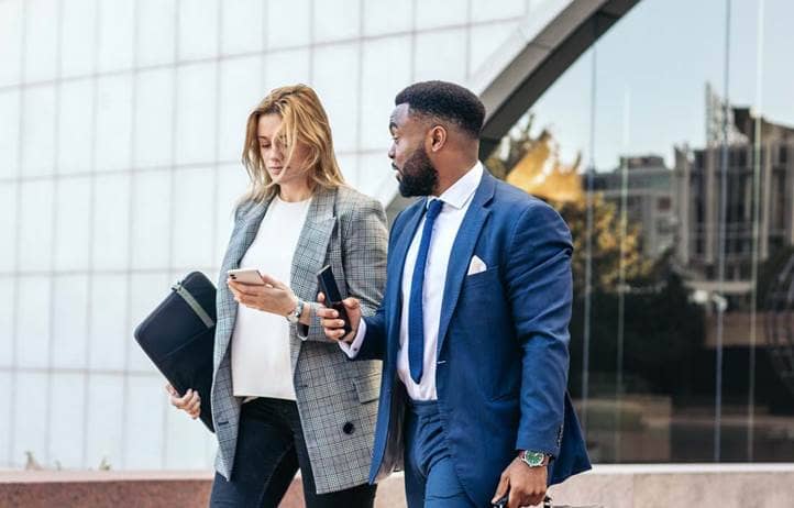 Business professionals walking and discussing Form 5500.