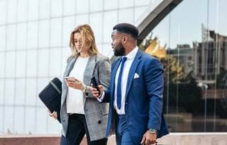 Business professionals walking and discussing Form 5500.