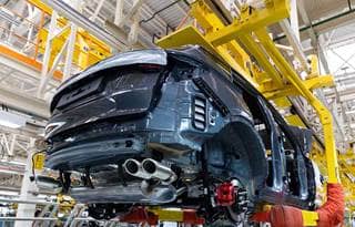 Automobile being assembled in a factory.