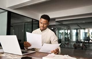 Business professional reviewing their documents.