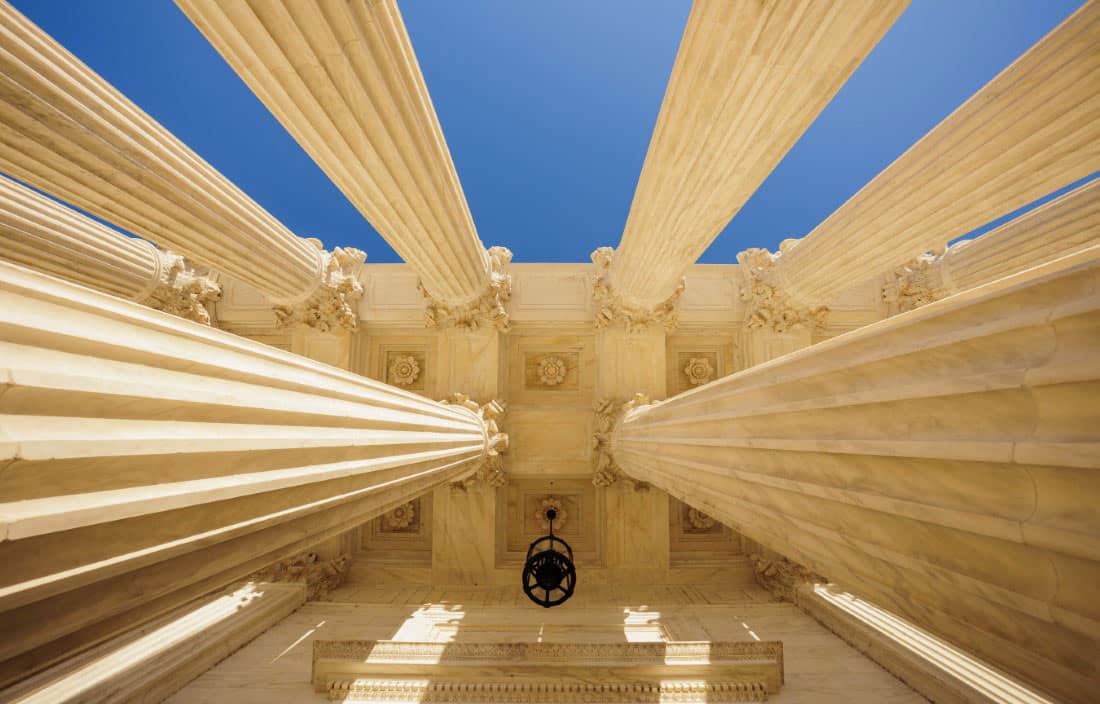 View looking up at pillars of a monument