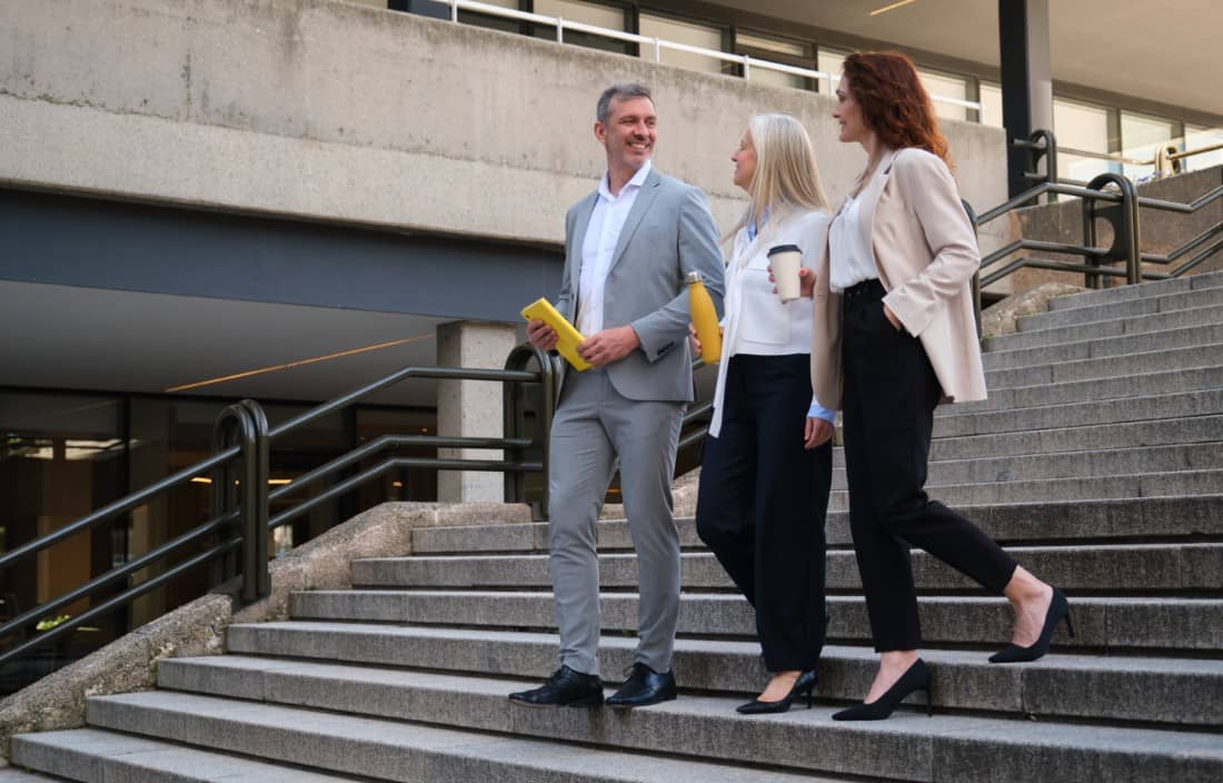 Two business professionals walking down stairs.