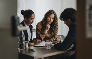 Business and healthcare professionals in a meeting.