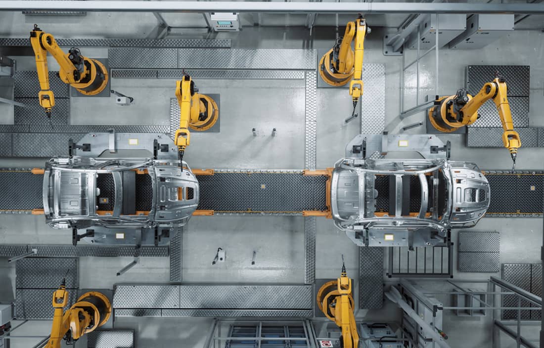 Aerial view of automobile being manufactured in a factory.