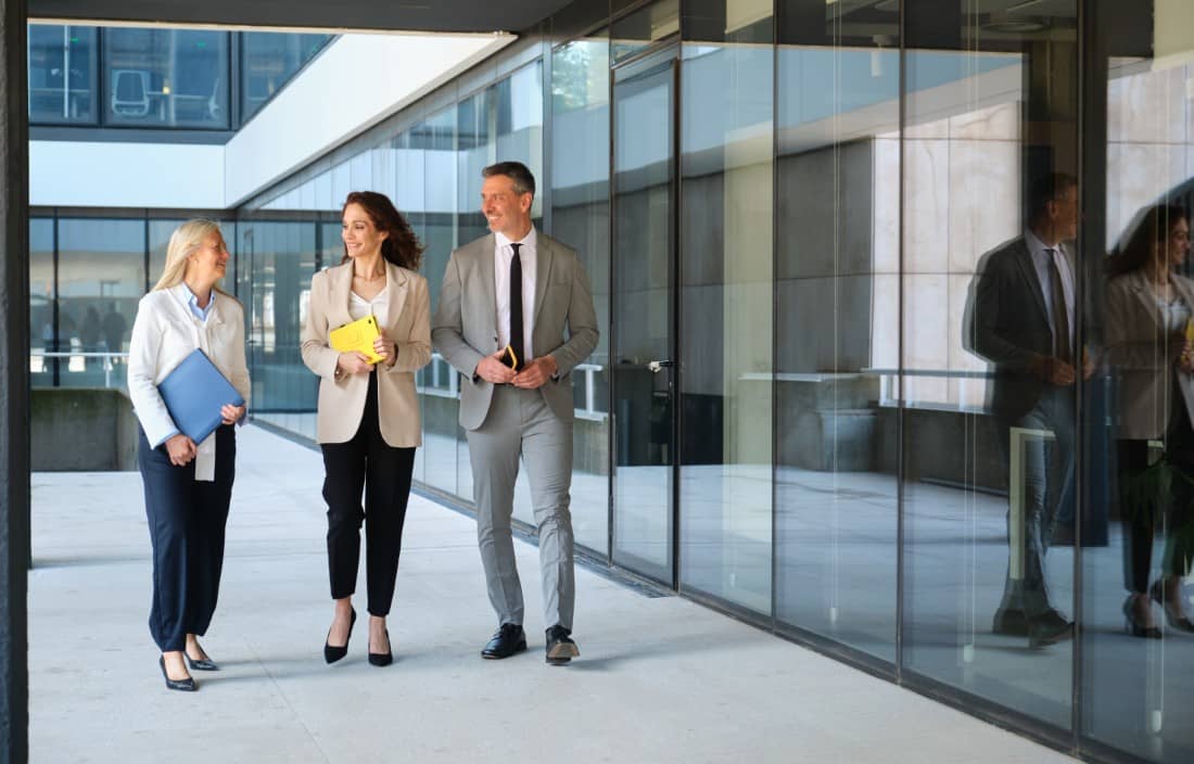 Business professionals walking down a hallway.