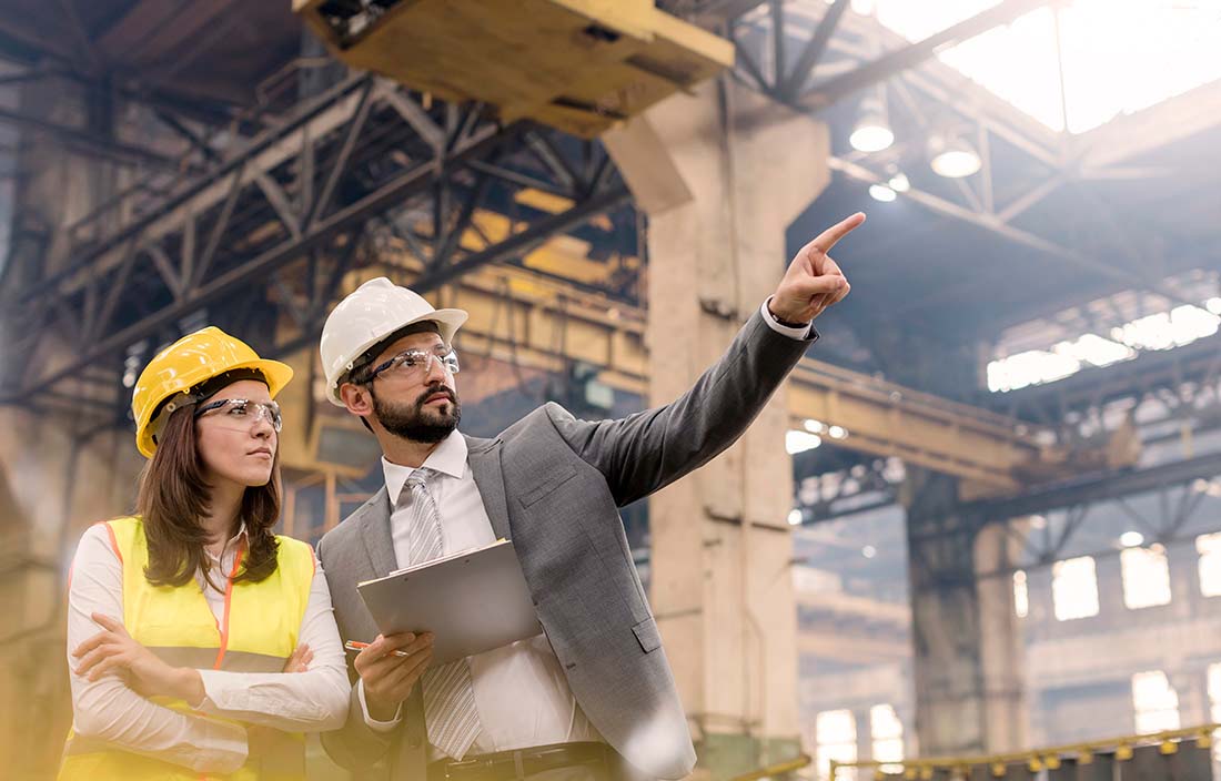 Two shipping and receiving employees discussing upcoming Immex changes in a warehouse. 